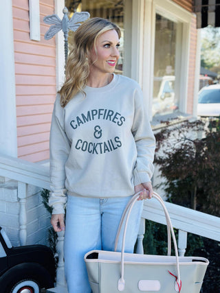 Campfires and Cocktails graphic crewneck sweatshirt

Beige fall sweatshirt with Campfires and Cocktails text

Cozy neutral crewneck with western lettering

Campfires and Cocktails pullover styled with boots

Casual fall graphic sweatshirt for cozy weekends