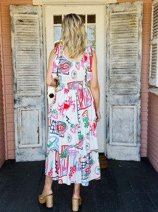 Model wearing the Kailyn Dress, a sleeveless printed tiered midi dress with shoulder ties

Colorful tiered midi dress with abstract print and adjustable tie straps

Skies Are Blue Kailyn Dress featuring vibrant print and flowy tiered silhouette

Sleeveless tie-shoulder summer midi dress with layered tiers and bold pattern