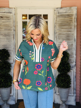 Kiara Top navy floral zip-front blouse with colorful floral print, drop shoulders, and contrast rib band trim.