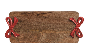 Mango wood serving board with glossy red enamel bow side handles crafted from cast aluminum.