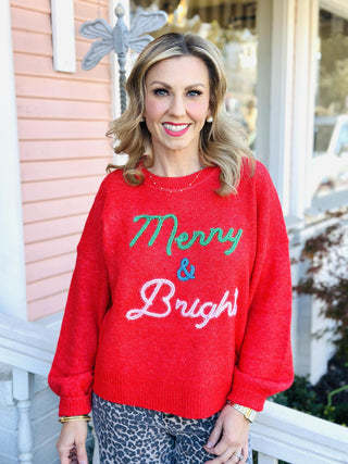 Red “Merry & Bright” Christmas sweater with colorful lettering

Festive red holiday pullover with green, blue, and white embroidery

Cozy red “Merry & Bright” knit sweater for the holidays