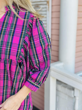 Woman wearing pink plaid Paige dress with puff sleeves

V-neck cotton poplin dress with ruffle collar and balloon sleeves

Pink and green plaid fall dress with statement sleeves