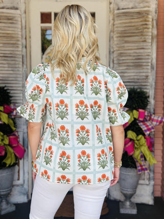 Floral puff sleeve blouse with tieable v-neck and orange flower block print

