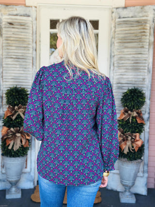 "Aria Second Glance Pink Top with geometric floral print in pink, teal, and navy"

"Women’s patterned blouse with V-neckline and long sleeves"

"Aria Second Glance Pink Top featuring bold pink and teal print with relaxed silhouette"