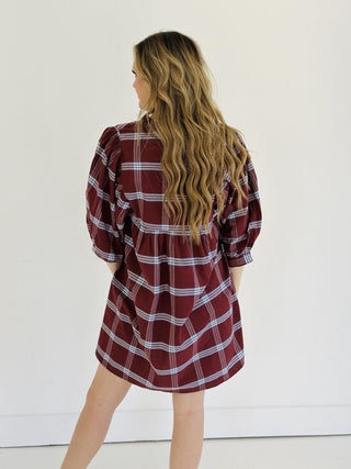 “Model wearing burgundy plaid puff sleeve Kira dress”

“V-neck cotton plaid mini dress with ruffle collar”

“Short fall dress with statement sleeves in plaid print”