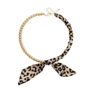 Maia ball bead scarf necklace with leopard print bow

Gold ball bead necklace with leopard scarf detail

Leopard print scarf bow statement necklace

Ball bead scarf necklace in neutral leopard print

Maia leopard scarf necklace with gold beads