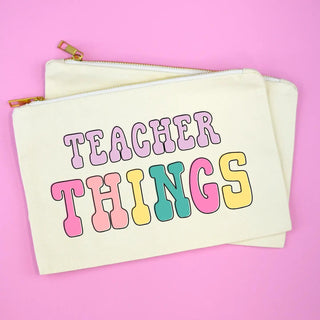 Teacher Things Cosmetic Bag in cream cotton canvas with colorful lettering and gold zipper.