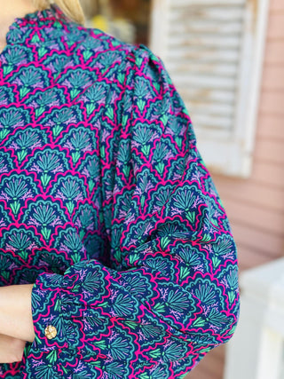 "Aria Second Glance Pink Top with geometric floral print in pink, teal, and navy"

"Women’s patterned blouse with V-neckline and long sleeves"

"Aria Second Glance Pink Top featuring bold pink and teal print with relaxed silhouette"