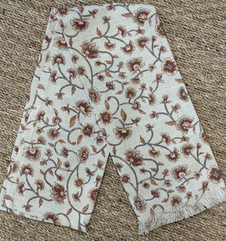 Cream floral cotton tea towel with delicate rust botanical vine print and fringed edge