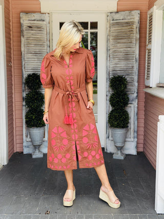 Uncle Frank Thea Dress in brown with vibrant pink embroidery, puff sleeves, collared neckline, pockets, and removable waist belt.