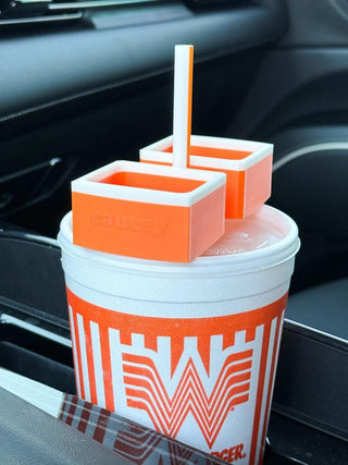 WhataSaucey dipping sauce holder for Whataburger drinks

Orange and white sauce holder clips onto straw over drink lid

WhataSaucey portable dipping sauce tray for car cupholder

Travel sauce cup holder fits over fast food drink

Whataburger-inspired WhataSaucey dipping cup attachment