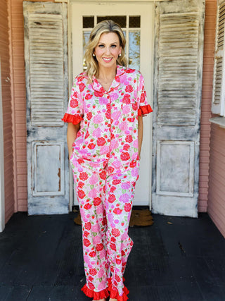 Rose Garden Pajama Pants Set with floral print, ruffle trim, and drawstring waist

Floral button-down pajama pants set with rose garden pattern and ruffled details

Women’s rose print pajama set with collar neckline and ruffle hem pants

Pink floral pajama pants set featuring drawstring waist and feminine ruffle trim