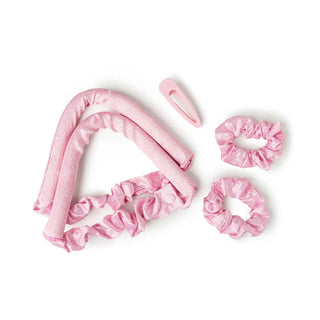 Pink satin heatless curling set with rod, two scrunchies, and a matching hair clip.
