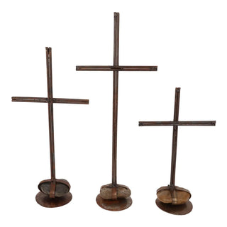 Rustic Rock Pedestal Cross with a dark metal finish and natural stone base, available in large, medium, and small sizes.