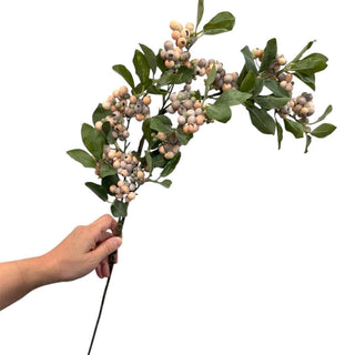 34.5-inch artificial frosty berry spray with muted beige berries, realistic green leaves, and a flexible natural stem for floral arrangements.