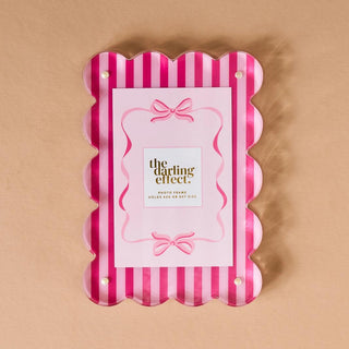 Pink sweetheart stripe acrylic scalloped photo frame with bow detail holding a 4x4 photo

Scalloped acrylic picture frame in pink stripes with magnetized panels for easy photo swapping

Sweetheart stripe acrylic frame for polaroids and 4x6 photos, modern scalloped edge design