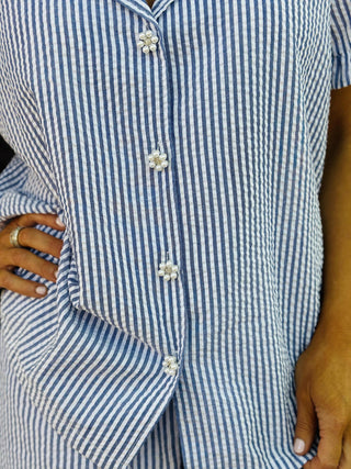 Blue cabana cotton seersucker short set with ruffle hem and button front top