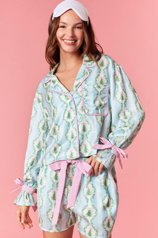 Myla Christmas satin pajama set with pink gingham ties

Blue holiday print satin pajama set with bow tie details

Myla festive satin pajama top and shorts set

Christmas printed satin pajamas with gingham trim

Women’s satin holiday pajama set with pink ribbon ties