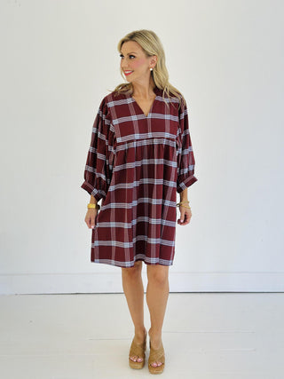 “Model wearing burgundy plaid puff sleeve Kira dress”

“V-neck cotton plaid mini dress with ruffle collar”

“Short fall dress with statement sleeves in plaid print”