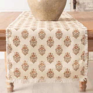 72" x 14" cotton table runner featuring a neutral block print floral pattern with fringe edges, perfect for everyday dining and seasonal tablescapes.