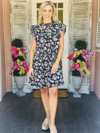 Woman wearing floral ruffle neck dress with flutter sleeves

Gabriela cotton cambric dress with short flutter sleeves and fall floral print