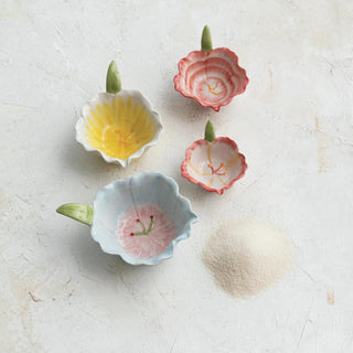 Set of four floral shaped ceramic prep bowls with petal edges and leaf handles