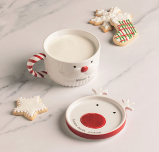 Cookies For Santa Mug Set featuring a ceramic Santa face mug with a candy cane handle and coordinating reindeer cookie plate lid.