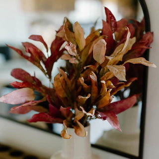 Warm fall leaf sprays in red, brown, and golden tones arranged on a neutral background

Set of three faux autumn leaf stems in multicolor for seasonal decorating

Realistic polyester fall sprays in shades of burgundy, copper, and chocolate brown
