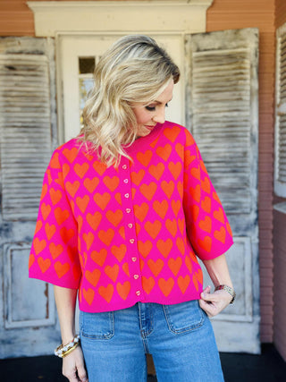 Pink and red heart print short sleeve sweater with heart buttons

Ivy Jane pink sweater with red heart pattern and button front

Heart felt pink sweater top with short sleeves and ribbed hem

Valentine heart print sweater top by Ivy Jane

Pink knit heart sweater with red hearts and decorative buttons