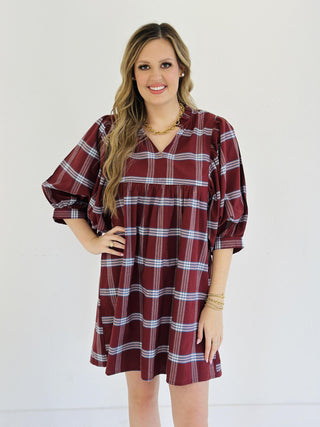“Model wearing burgundy plaid puff sleeve Kira dress”

“V-neck cotton plaid mini dress with ruffle collar”

“Short fall dress with statement sleeves in plaid print”