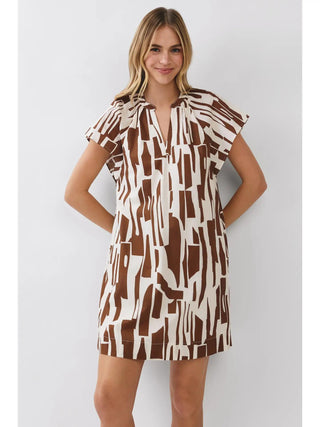 Mary Dress in brown and ivory abstract print with cap sleeves, open V-neck, side pockets, and relaxed shift silhouette.