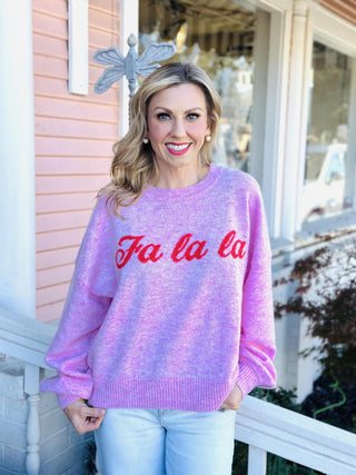 Pink “Fa La La” holiday sweater with red lettering

Bubblegum pink Christmas sweater with festive script

Cozy pink “Fa La La” knit pullover for the holidays
