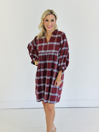 “Model wearing burgundy plaid puff sleeve Kira dress”

“V-neck cotton plaid mini dress with ruffle collar”

“Short fall dress with statement sleeves in plaid print”