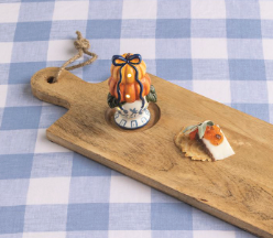 Hand-painted ceramic Pumpkin Topiary Light-Up Sitter with stacked orange pumpkins, blue bow, LED lights, and blue chinoiserie-inspired pedestal base.