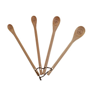 Set of four carved beech wood measuring spoons with engraved tablespoon and teaspoon sizes, tied together with leather cord