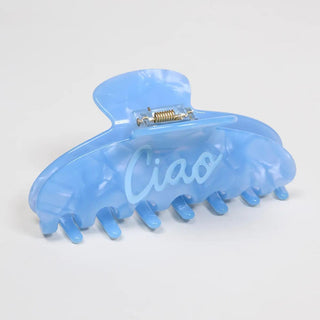 Blue Ciao claw hair clip with bold lettering