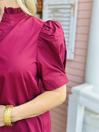 Burgundy puff sleeve blouse with ruffled collar and button-down front