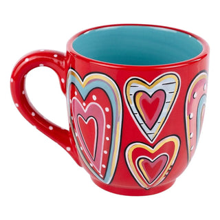 Red ceramic mug with colorful all over heart pattern and turquoise interior