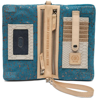 “Consuela Shiloh Uptown Crossbody teal suede with gold embroidery”

“Shiloh Consuela embroidered floral crossbody with wristlet strap”

“Interior of Consuela Shiloh Uptown Crossbody with card slots and zipper pockets”

“Consuela Shiloh teal suede wallet bag with detachable strap”

“Embroidered Consuela crossbody wallet in teal and bronze metallic”
