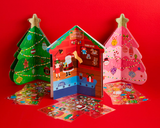 Pink and green Christmas tree sticker books with gold star toppers and decorative stickers.

Gingerbread house Christmas sticker book with Santa and elf illustrations.

Children’s Christmas activity books with festive stickers and foldable designs.