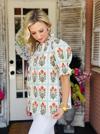 Floral puff sleeve blouse with tieable v-neck and orange flower block print

