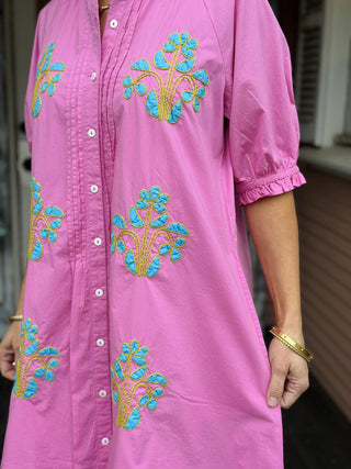 Ivy Jane Evie Dress in bright pink cotton with turquoise blocked floral embroidery, puff sleeves, pintuck front, and button-down design.