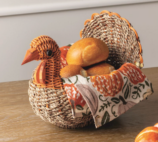 Seagrass Turkey Basket with woven turkey head and tail, paired with a fall floral flour sack hand towel for Thanksgiving entertaining and seasonal décor.