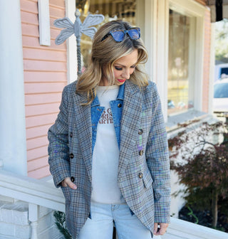 Woman wearing a gray plaid double-breasted blazer with denim shirt insert detail

Darlene Double Blazer in plaid with double-breasted buttons and denim collar detail

Plaid blazer with denim shirt insert, double-breasted front, and long sleeves

Structured plaid blazer layered with built-in denim shirt insert