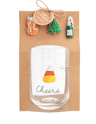 Simply Charming Wine Glass Set featuring a stemless wine glass with interchangeable magnetic holiday charms including a pumpkin, Christmas tree, champagne bottle, and candy corn.