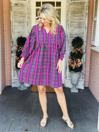 Woman wearing pink plaid Paige dress with puff sleeves

V-neck cotton poplin dress with ruffle collar and balloon sleeves

Pink and green plaid fall dress with statement sleeves