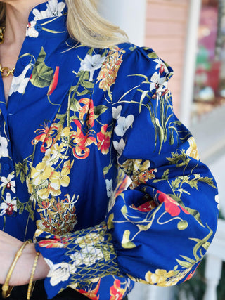 Elowyn Top with navy floral print and ruffle mock neck

Navy blue floral long sleeve blouse with ruffle collar

Elowyn Top floral blouse with smocked cuffs and high neckline

Romantic navy floral top with soft ruffle details

Lightweight floral blouse with mock neck and gathered sleeves