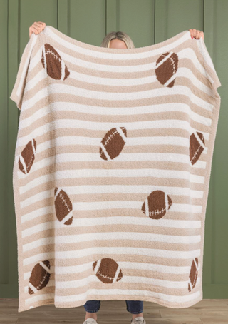 Tailgate Chenille Blanket featuring tan and cream stripes with football accents, made from soft plush chenille fabric.