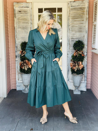 "Laney Dress in sea green with V-neckline, waist tie belt, long sleeves, and tiered hem"

"Sea green midi dress with adjustable waist belt, V-neck, and side pockets – Laney Dress"

"Women’s long sleeve wrap-style dress in sea green with tie waist and pockets"