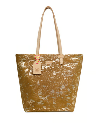 Consuela Marlow Daily Tote featuring a metallic gold finish with white splatter design, natural leather handles, and a roomy everyday silhouette.